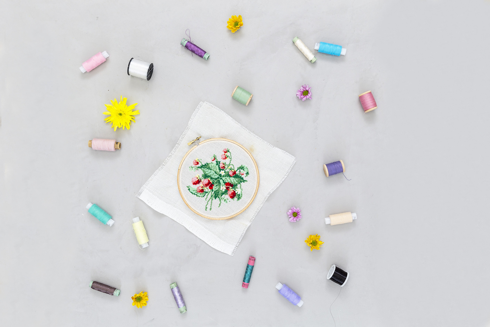 Samples of embroidered badges arranged on table